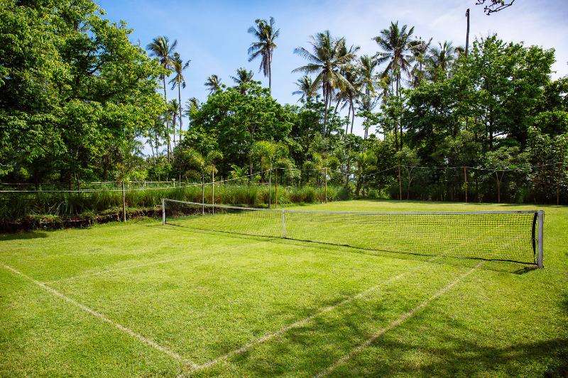 a grass tennis court in a holiday villa in Bali