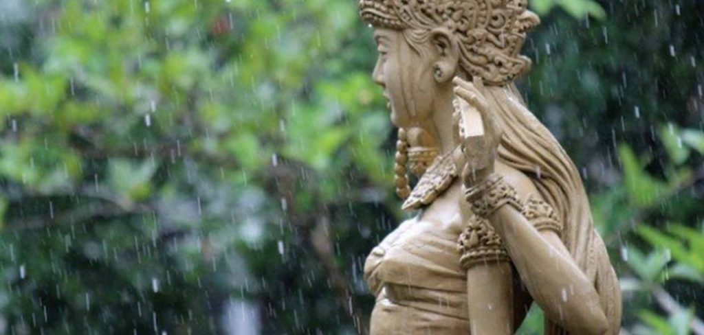 rain falling on statue in Bali during rainy season