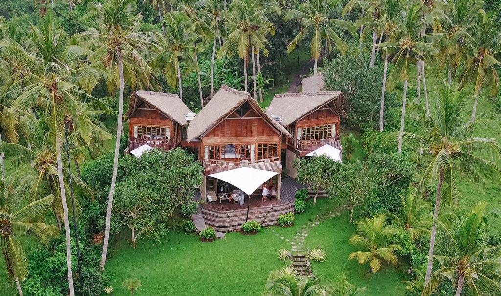 A Balinese villa set amongst lush exotic landscape and coconut trees
