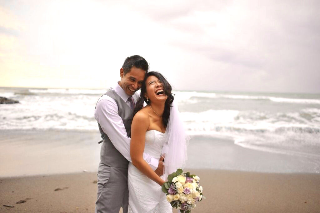 newlyweds embrace on the beach