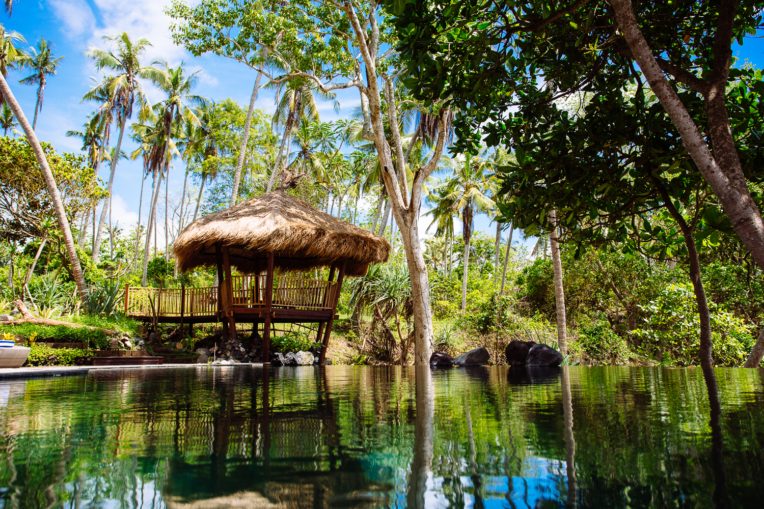 Swimming pool cabana among lush landscape