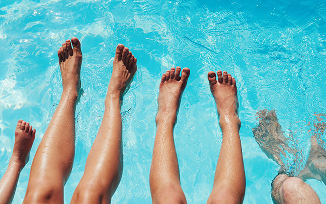 children's feet in the swimming pool